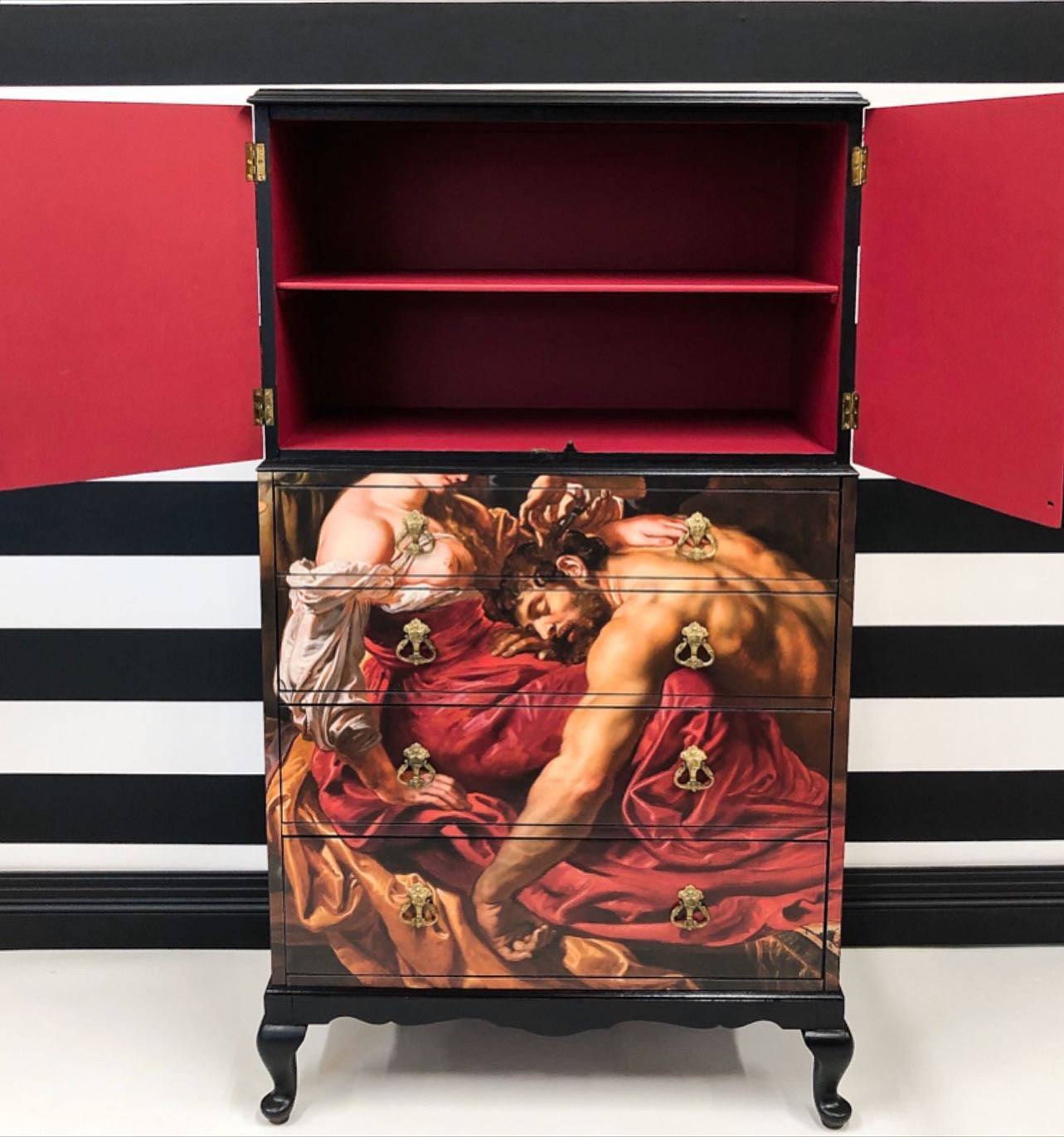 Upcycled cocktail cabinet with a classic art design on the front
